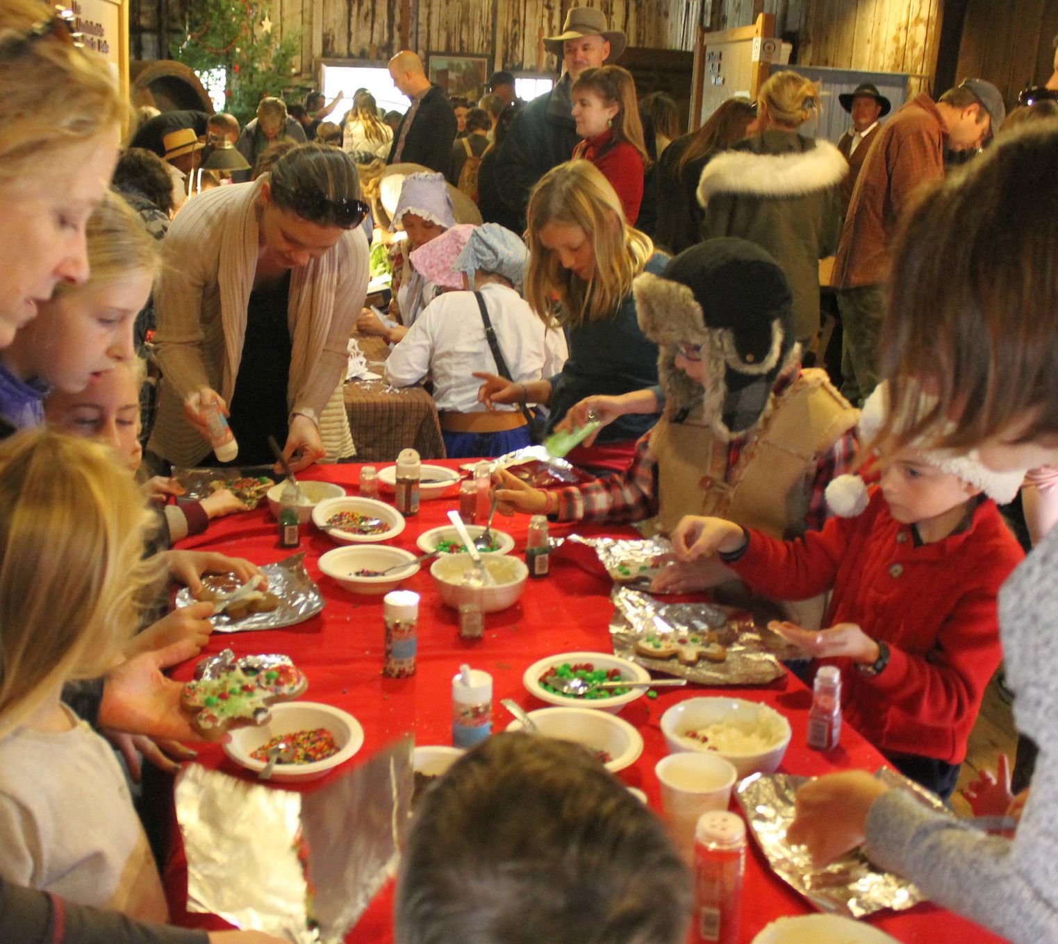 Busy hands decorating gingerbread men at the Bale Grist Mill